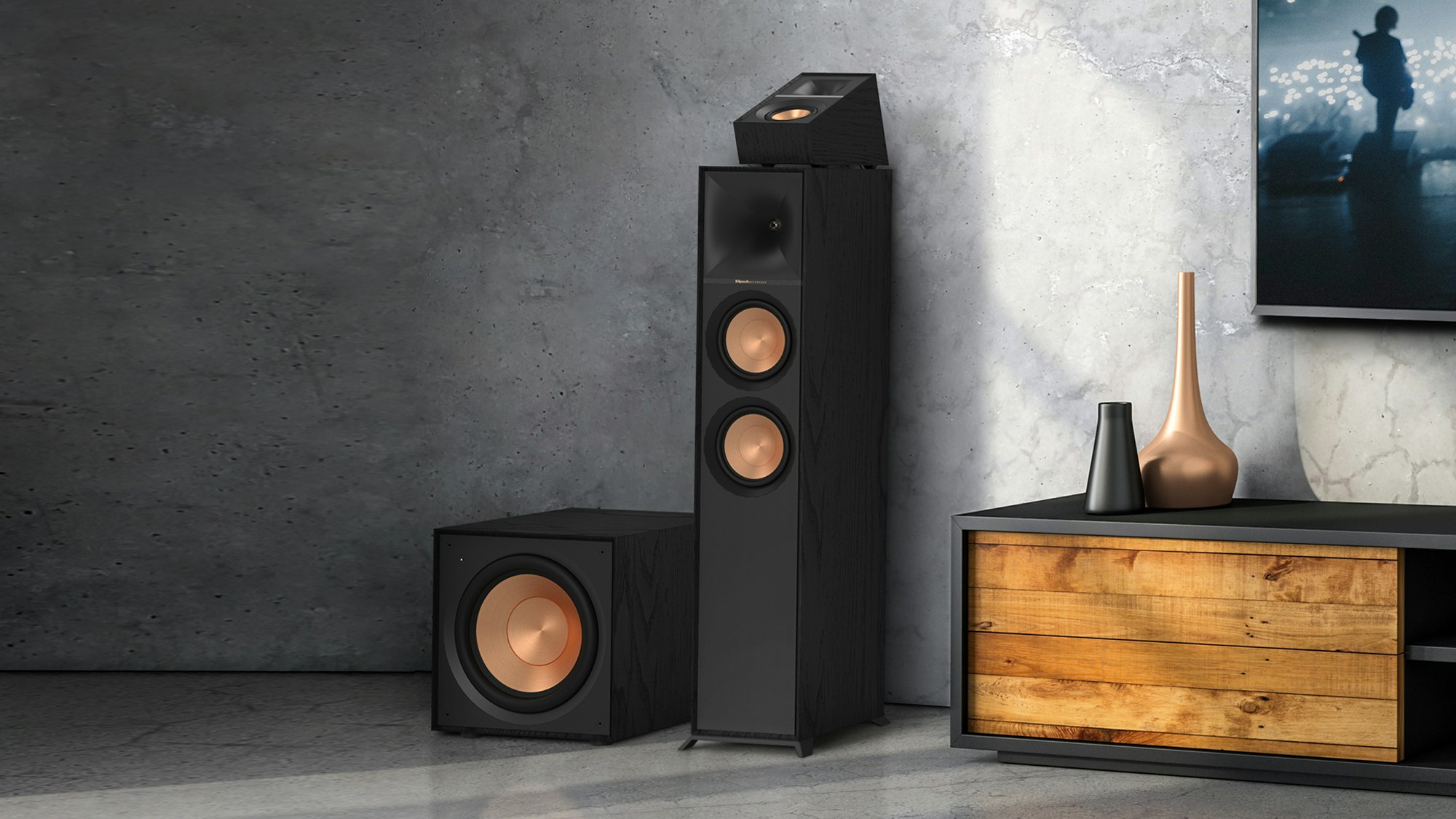 Reference Subwoofer R-101SW next to a Klipsch floorstanding speaker with Dolby Atmos elevation topper